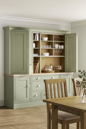 A pale green laura ashley whitby kitchen with wooden floor and wooden worktops