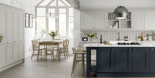 Navy Blue kitchen island with a muted gray wall unit and pantry. A dining table is shown and there are gemoetric tiles on the walls.